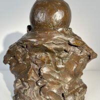 Alt text: Bronze sculpture of a baby