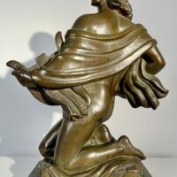 Alt text: Bronze sculpture of a muse