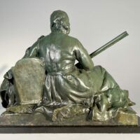 Alt text: Bronze sculpture of a pioneer woman