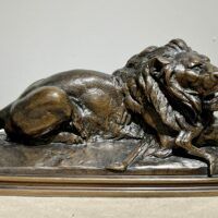 Alt text: sculpture of a lion over a dead animal