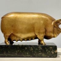 Alt text: Bronze sculpture of a pig