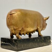 Alt text: Bronze sculpture of a pig