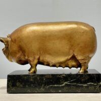 Alt text: Bronze sculpture of a pig