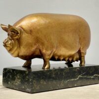 Alt text: Bronze sculpture of a pig