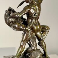 Alt text: Bronze sculpture of a man fighting a minotaur