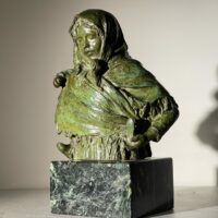 Alt text: Bronze sculpture of woman with child on her back