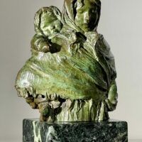 Alt text: Bronze sculpture of woman with child on her back