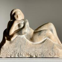 Alt text: Marble carving of a reclining nude woman