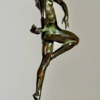 Alt text: Bronze sculpture of a nude woman skipping and holding a fish in one hand