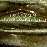 Alt text: Bronze sculpture, signature detail