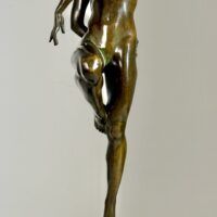 Alt text: Bronze sculpture of a nude woman skipping and holding a fish in one hand