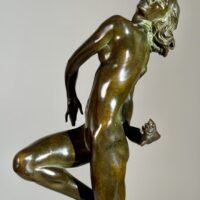 Alt text: Bronze sculpture of a nude woman skipping and holding a fish in one hand
