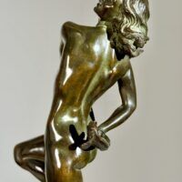 Alt text: Bronze sculpture of a nude woman skipping and holding a fish in one hand