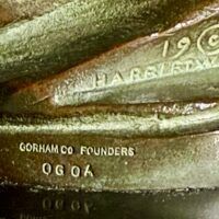 Alt text: Bronze sculpture, foundry mark detail