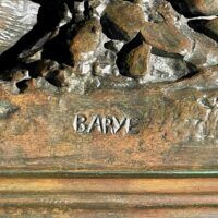 Alt text: Signature detail of a bronze sculpture