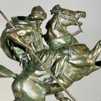 Alt text: Bronze sculpture of a horseman killing a lion