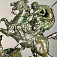 Alt text: Bronze sculpture of a horseman killing a lion