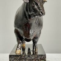 Alt text: Bronze sculpture of a bull