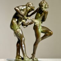 Alt text: Bronze sculpture of two figures holding a grape vine