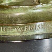 Alt text: Bronze sculpture, signature detail