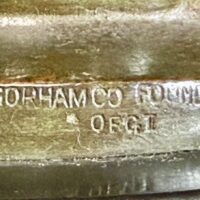 Alt text: Bronze sculpture, foundry mark detail