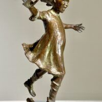 Alt text: Bronze sculpture of a girl roller skating on one foot