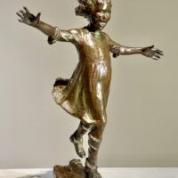 Alt text: Bronze sculpture of a girl roller skating on one foot