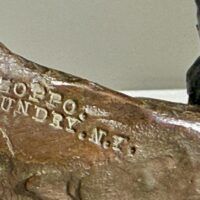 Alt text: Bronze sculpture, foundry mark detail
