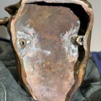 Alt text: Bronze sculpture, underside