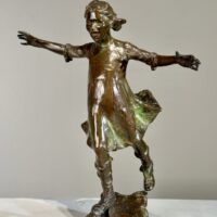Alt text: Bronze sculpture of a girl roller skating on one foot