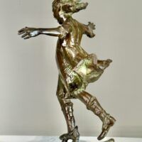 Alt text: Bronze sculpture of a girl roller skating on one foot