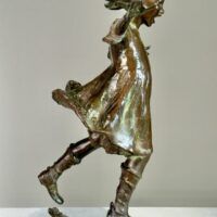 Alt text: Bronze sculpture of a girl roller skating on one foot