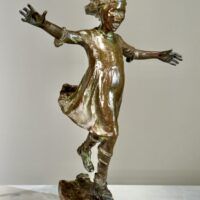 Alt text: Bronze sculpture of a girl roller skating on one foot