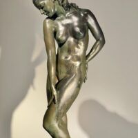 Alt text: Bronze sculpture of a nude woman