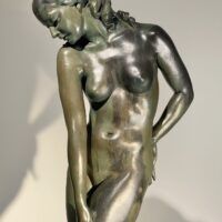 Alt text: Bronze sculpture of a nude woman