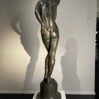 Alt text: Bronze sculpture of a nude woman