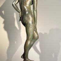Alt text: Bronze sculpture of a nude woman