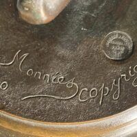 Alt text: Bronze sculpture, signature detail