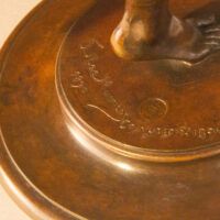 Alt text: Bronze sculpture, inscription detail