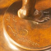 Alt text: Bronze sculpture, inscription detail