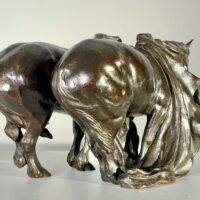 Alt text: Bronze sculpture of two horses