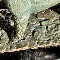 Alt text: Bronze sculpture of two poodles, detail