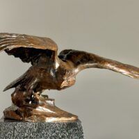 Alt text: Bronze sculpture of an eagle with wings spread