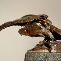 Alt text: Bronze sculpture of an eagle with wings spread