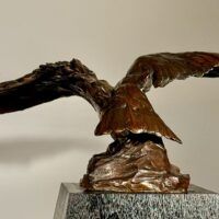 Alt text: Bronze sculpture of an eagle with wings spread