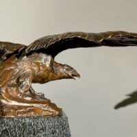 Alt text: Bronze sculpture of an eagle with wings spread