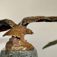 Alt text: Bronze sculpture of an eagle with wings spread