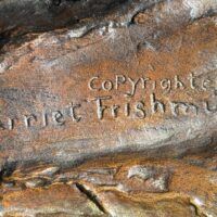 Alt text: Bronze sculpture, signature detail