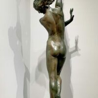 Alt text: bronze sculpture of a woman standing