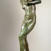 Alt text: Bronze sculpture of a young nude woman standing among frogs